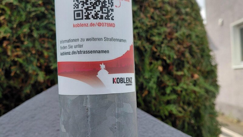 QR-Code auf Pfosten eines Straßenschildes.